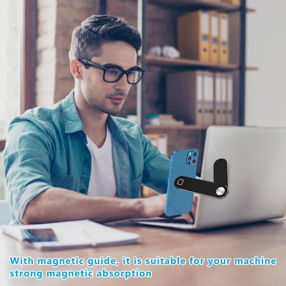 Black aluminium magnetic phone holder clipped to the side of a silver laptop