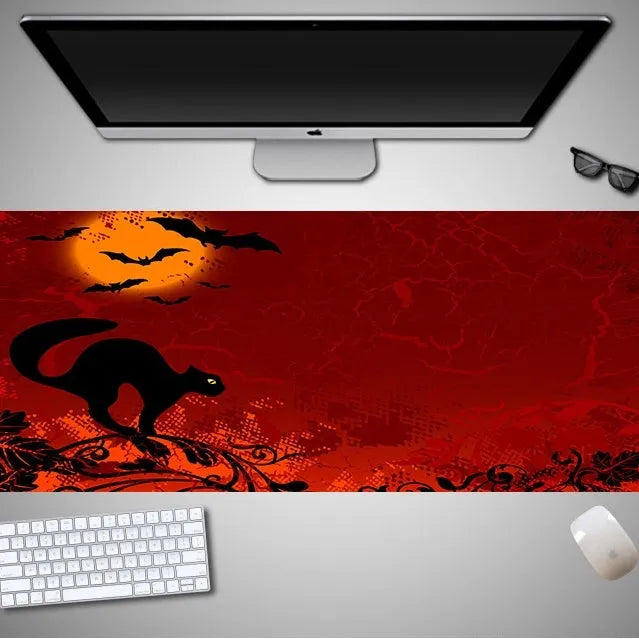 Oversized Halloween-themed rubber cloth gaming mouse pad on a desk.
