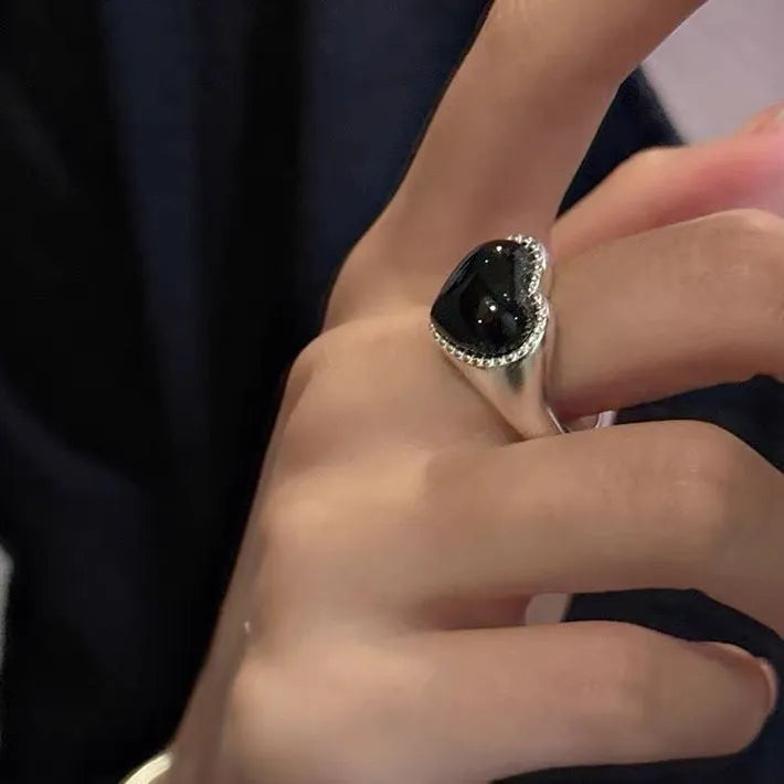 Sterling silver ring with a heart-shaped black agate stone and an adjustable open mouth design.