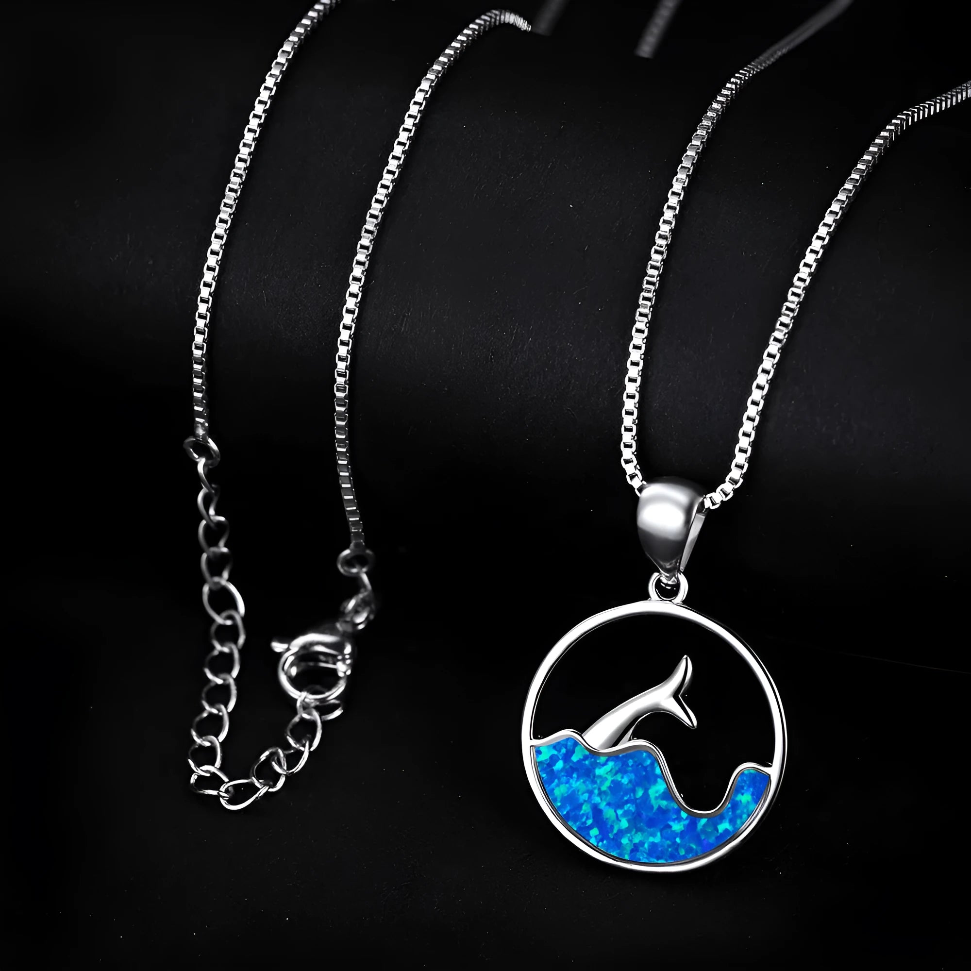 White gold plated fishtail pendant necklace with round blue opal stone on a 45 cm chain.
