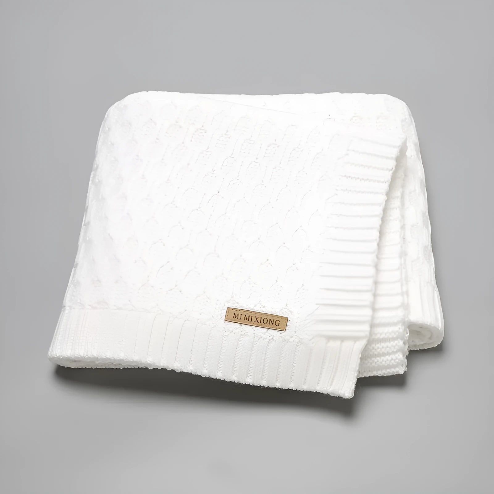 Solid colour infant hug blanket with textured lines in beige khaki, size 70 by 90 cm.