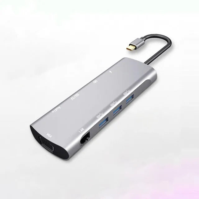 Grey aluminium USB-C docking station showing HDMI, VGA, USB 3.0, and PD charging ports