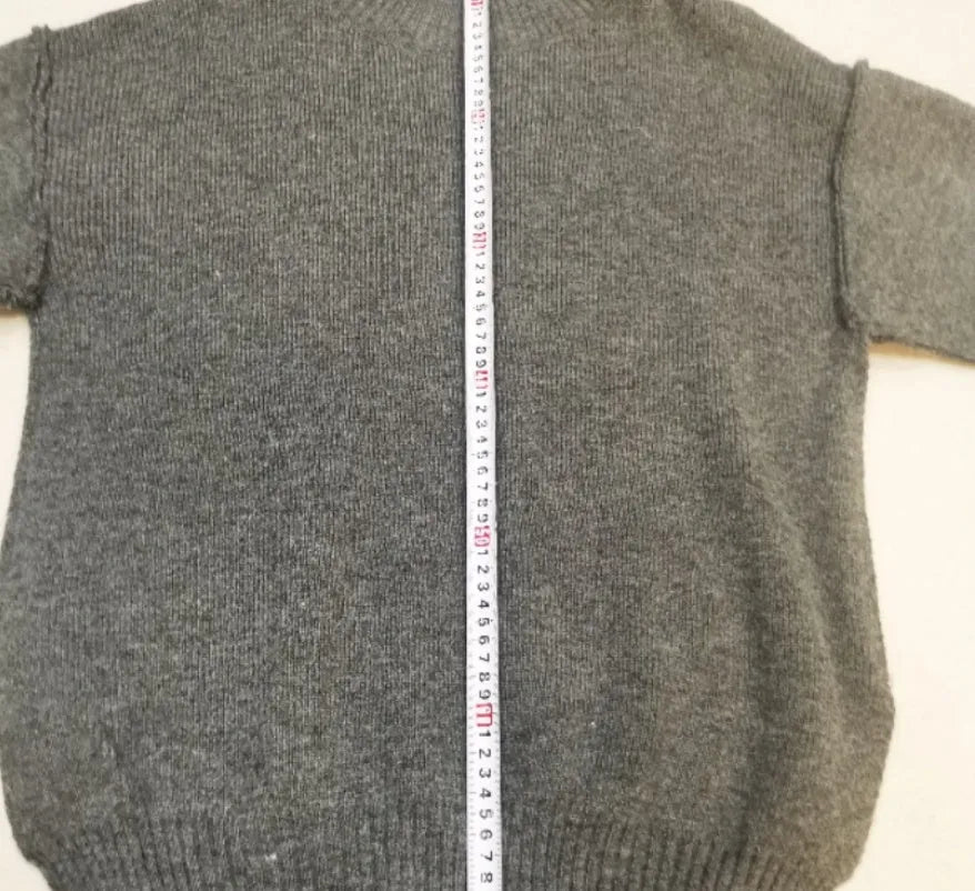Women's knitted two-piece suit with side-slit sleeve jumper and trousers in dark grey.