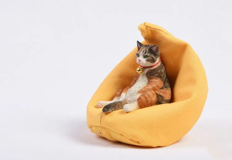 Lazy cat and sofa miniature car dashboard ornament made from resin, approximately 7.5cm high.