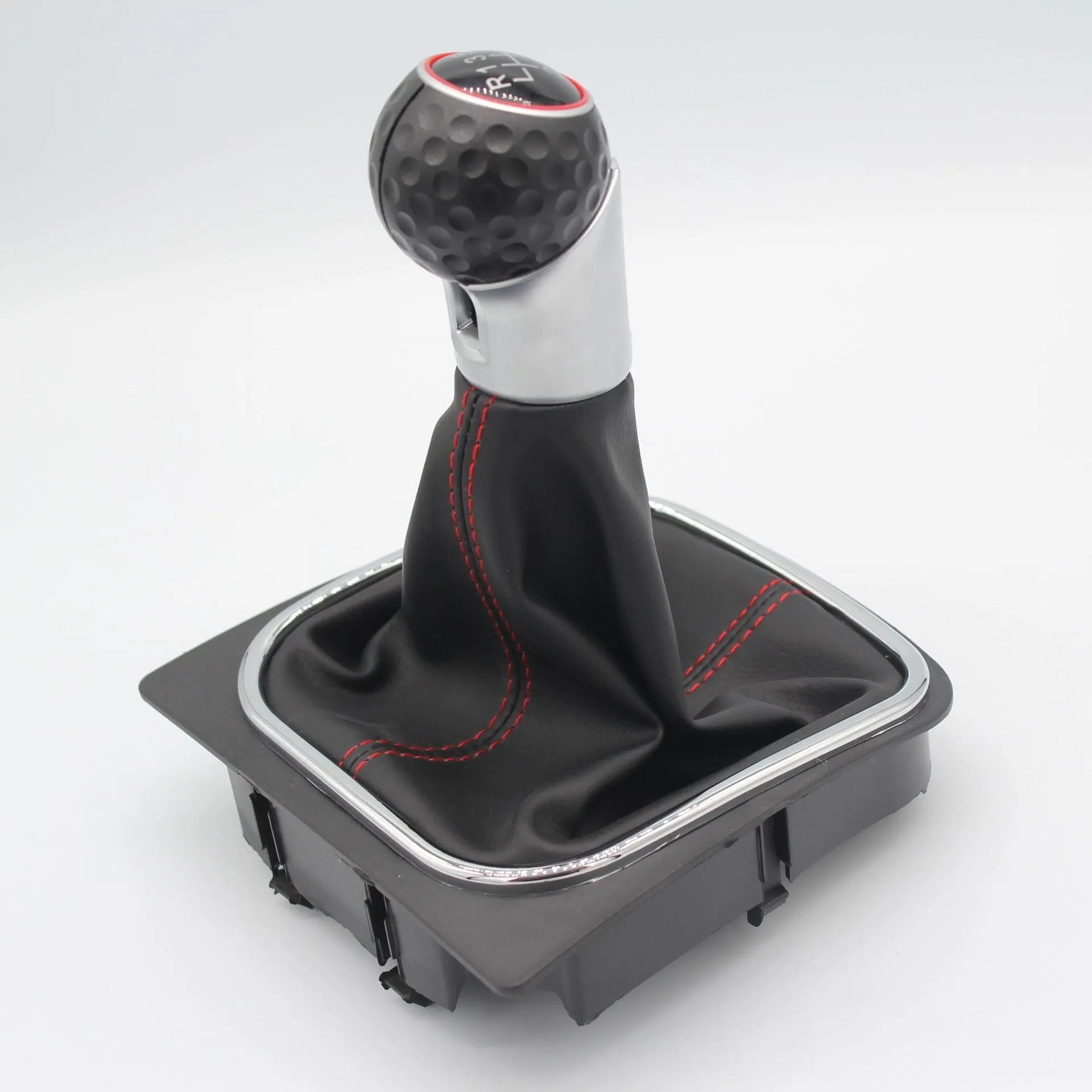 Leather gear shift knob with attached dust boot for Volkswagen Golf manual transmission.