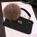 Hairball plush textured TPU back case for iPhone on a dark green grid background.