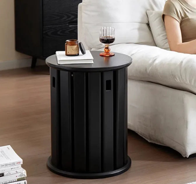 Stackable iron dining stool with large round seat in smoked black finish.