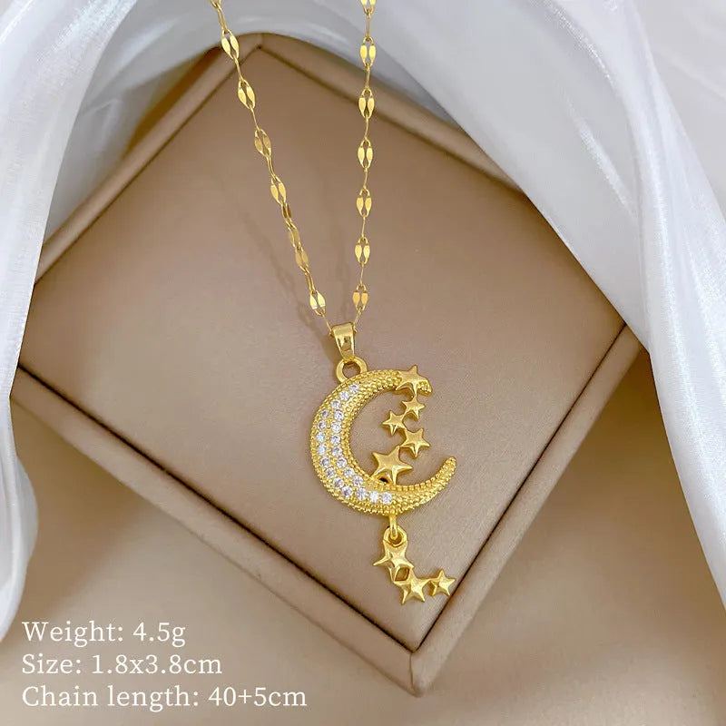 Geometric moon pendant necklace with tassel on a stainless steel chain.