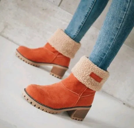 Women's black suede mid-tube snow boots with a thick flat heel and round toe on a white background.