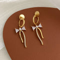 Asymmetric micro-set zirconia C-shaped light luxury earrings in copper, ear clip style on a woman