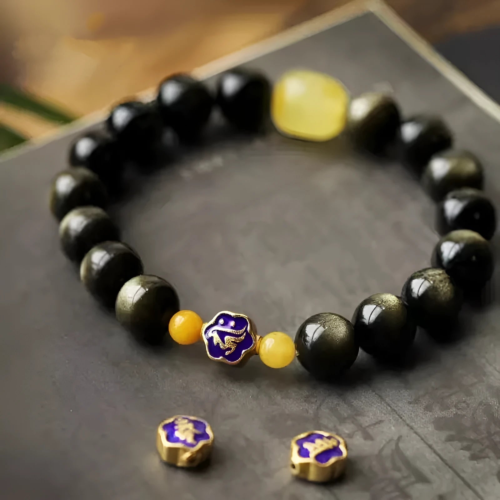 Golden obsidian bracelet with 10mm geometric zodiac beads on adjustable cord