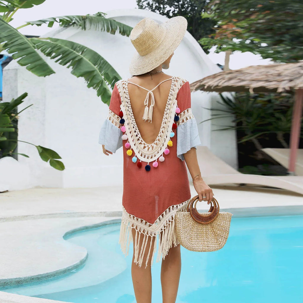 Orange hand-crochet beach overskirt with floral pattern and tassels, part of a matching set