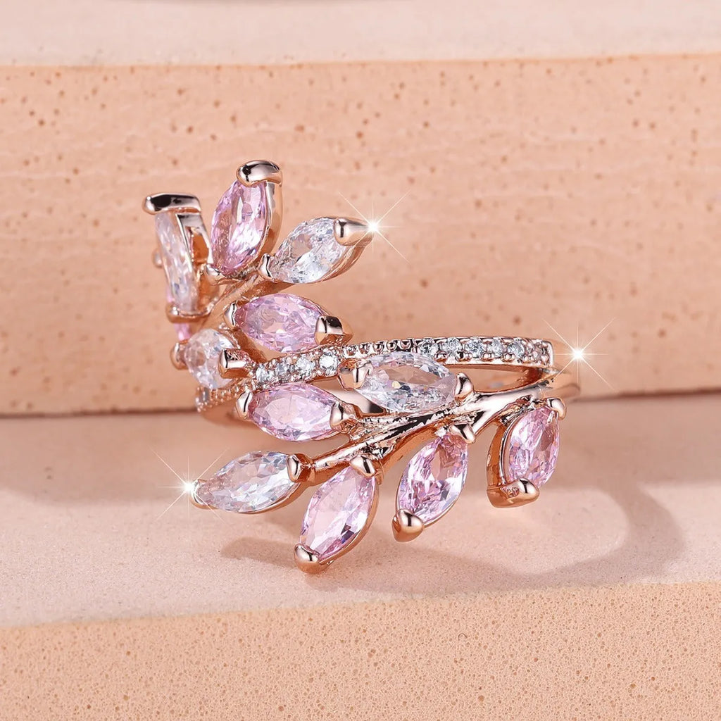 Adjustable copper ring with a detailed leaf design and zircon accents in various colour options.