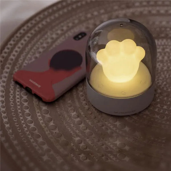 Grey and pink cat paw shaped night light with USB charging port and music box functions