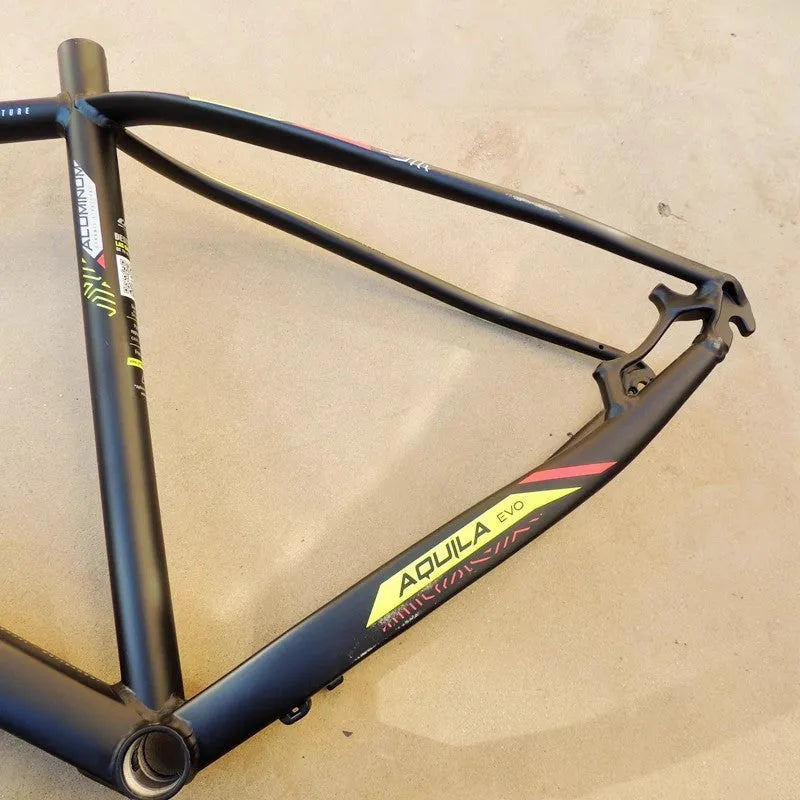 Black green aluminium mountain bike frame for 29-inch wheels with inner cable routing and disc brake mounts.
