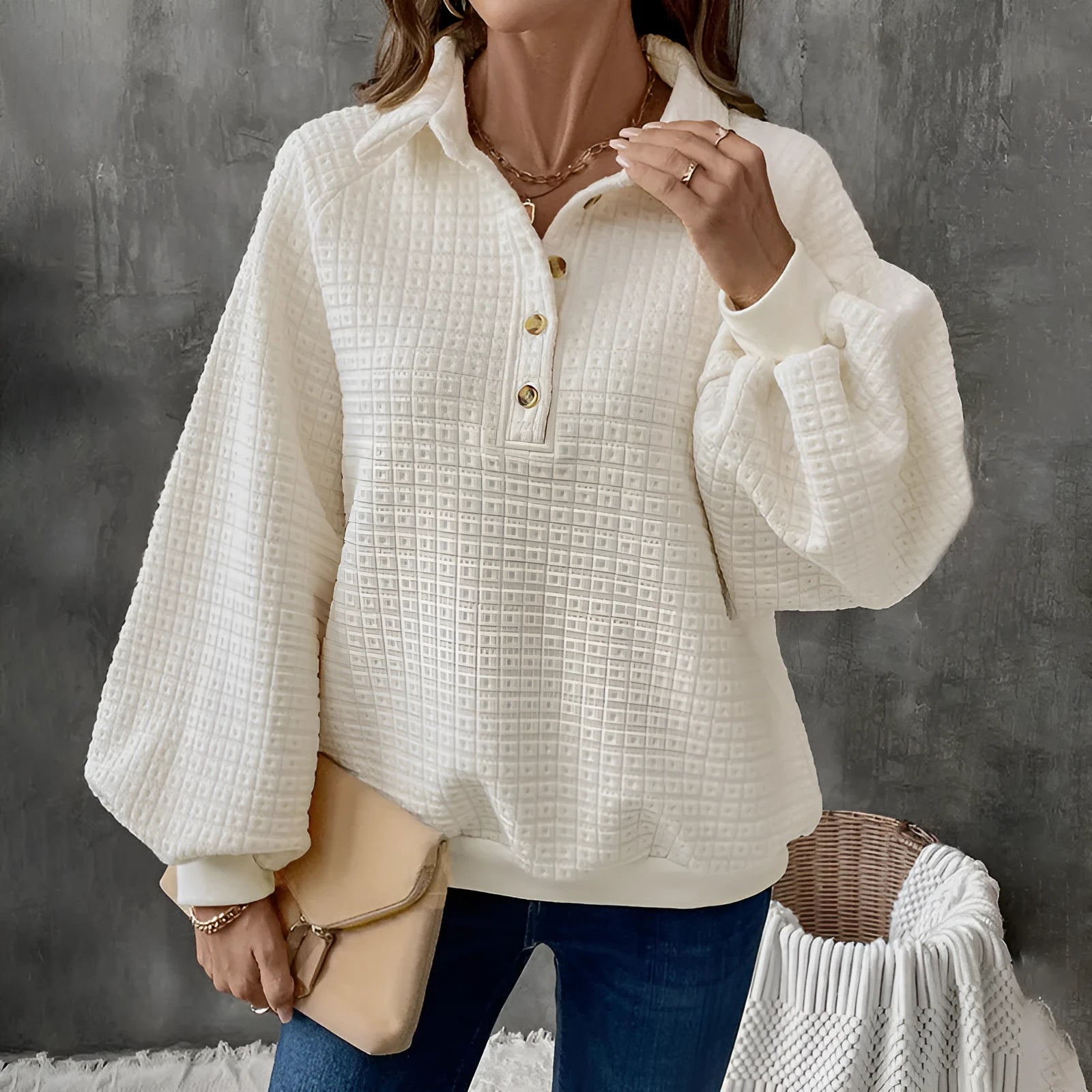 Beige women's polo collar sweater with long sleeves and a textured knit fabric.