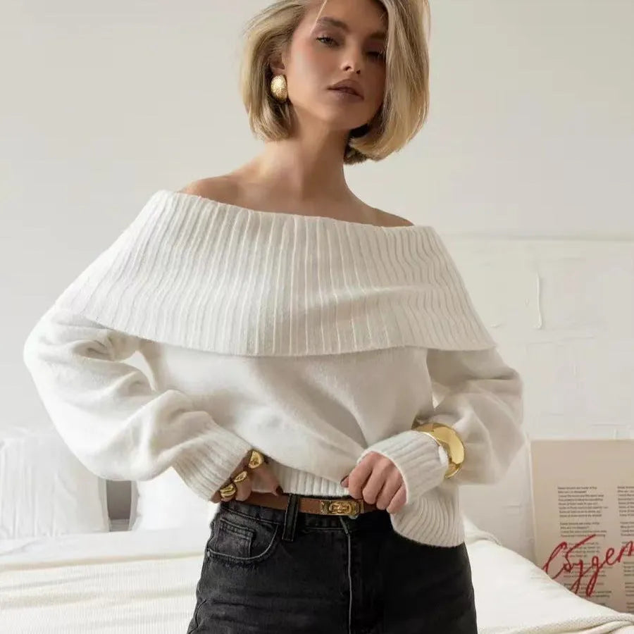 Grey off-the-shoulder women's sweater with a 3D pattern and regular sleeves on a hanger.