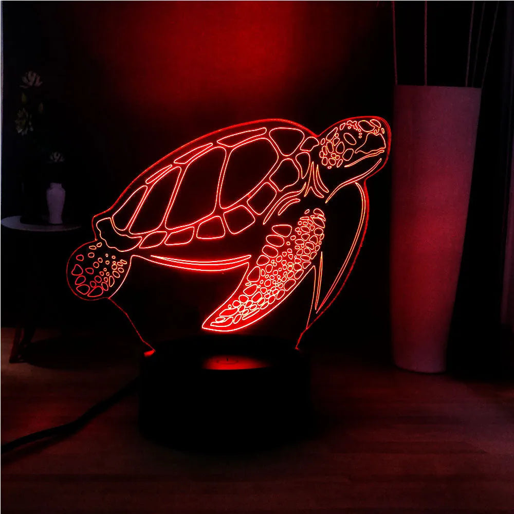 3D green turtle-shaped LED night light with colourful glow, showing remote control and USB cable.