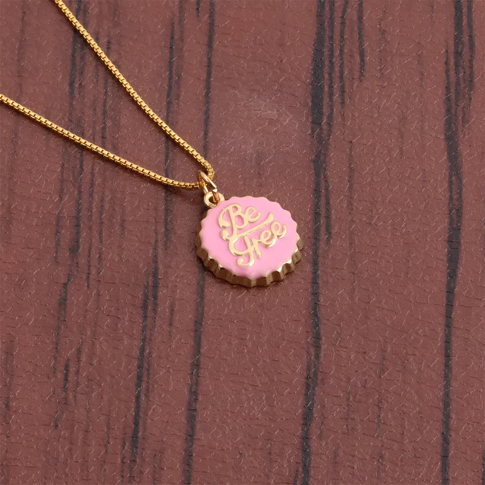 Copper bottle cap pendant necklace on a 40 cm box chain with an 18K gold colour electroplated finish.