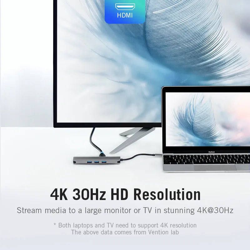 Deep grey USB-C to HDMI hub with Ethernet, USB ports, and memory card slots on a desk.