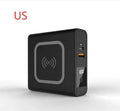Black and white portable power bank with flip-out international plug adaptors showing PD20W and Qi wireless logos.