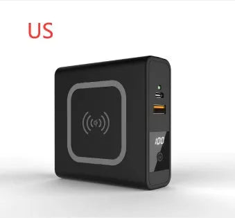 Black and white portable power bank with flip-out international plug adaptors showing PD20W and Qi wireless logos.