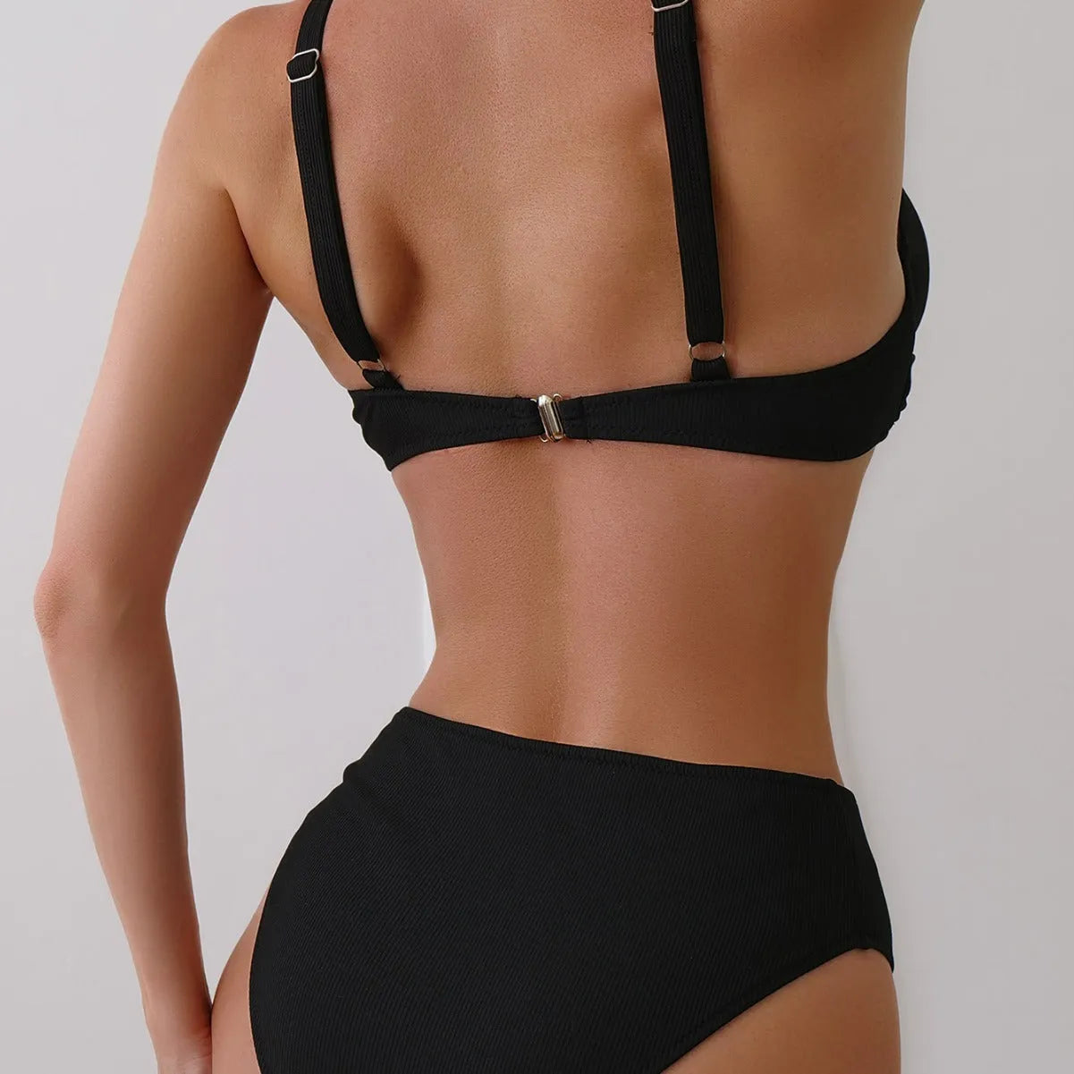 Women's solid colour bikini set in polyester rib fabric, shown on a hanger.