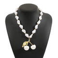 Women's adjustable fruit pendant necklace with pearl chain in gold or white colour.
