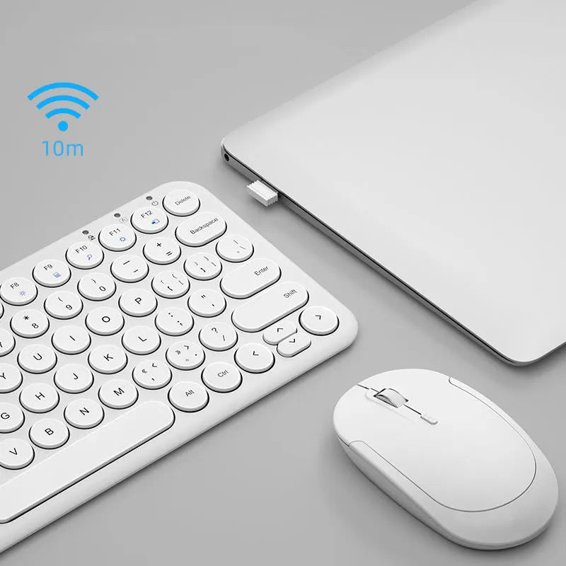 Ultra-thin white wireless keyboard and mouse set with USB receiver on a desk.