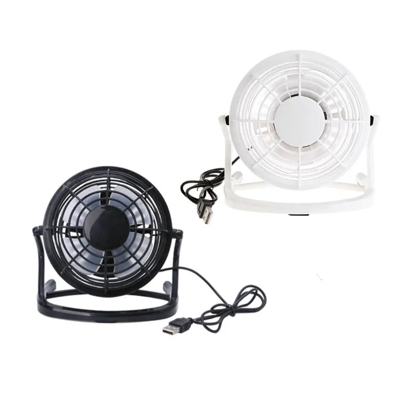 Mini portable USB desk fan with adjustable angle in black colour beside laptop