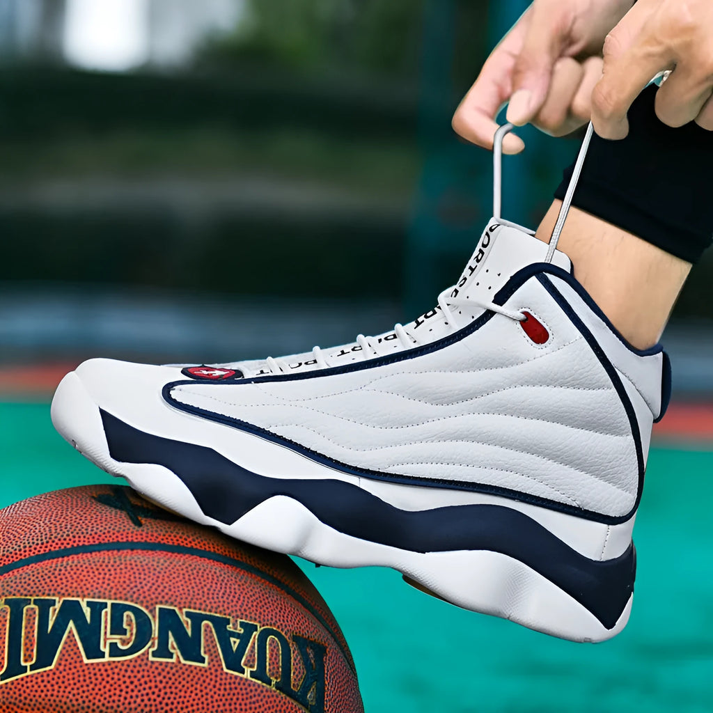 High-top basketball shoe in white and red with mesh upper, thick rubber sole, and lace-up front.