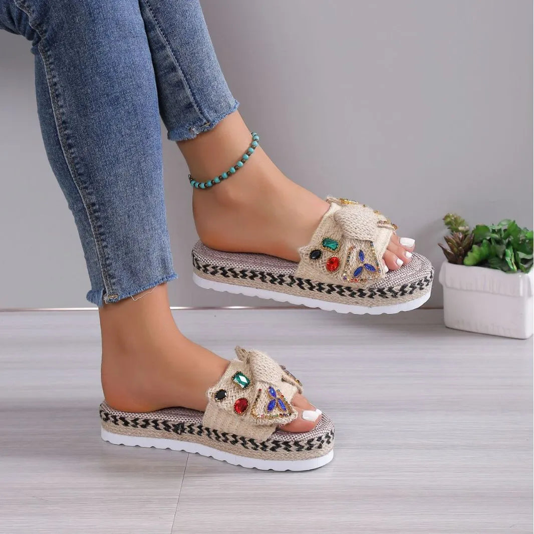 Creamy-white women's platform sandals with a cloth upper, beach bow detail, and slip-on sleeve design.