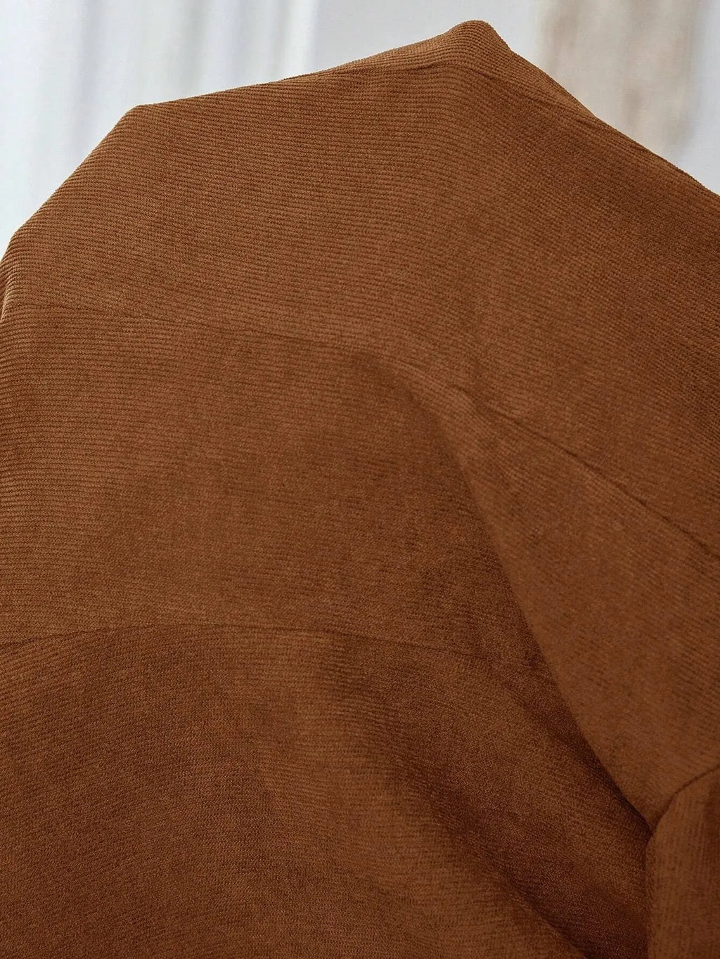 Brown single-breasted men's leisure suit coat with lapel collar and long sleeves.