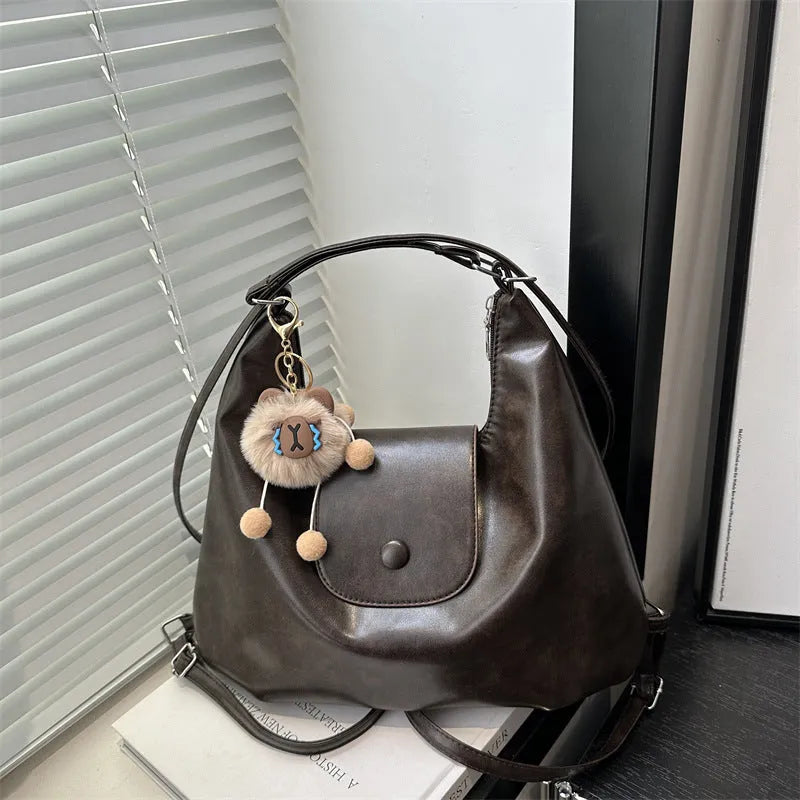PU leather commuter backpack in horizontal square shape with single shoulder strap