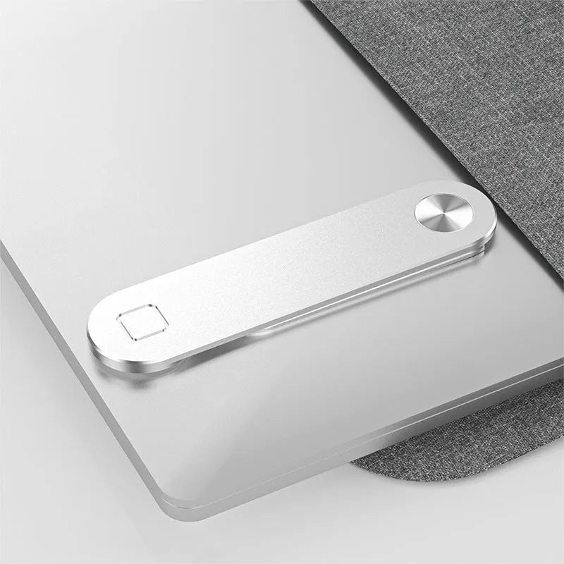 Black aluminium magnetic phone holder clipped to the side of a laptop screen with a smartphone attached.