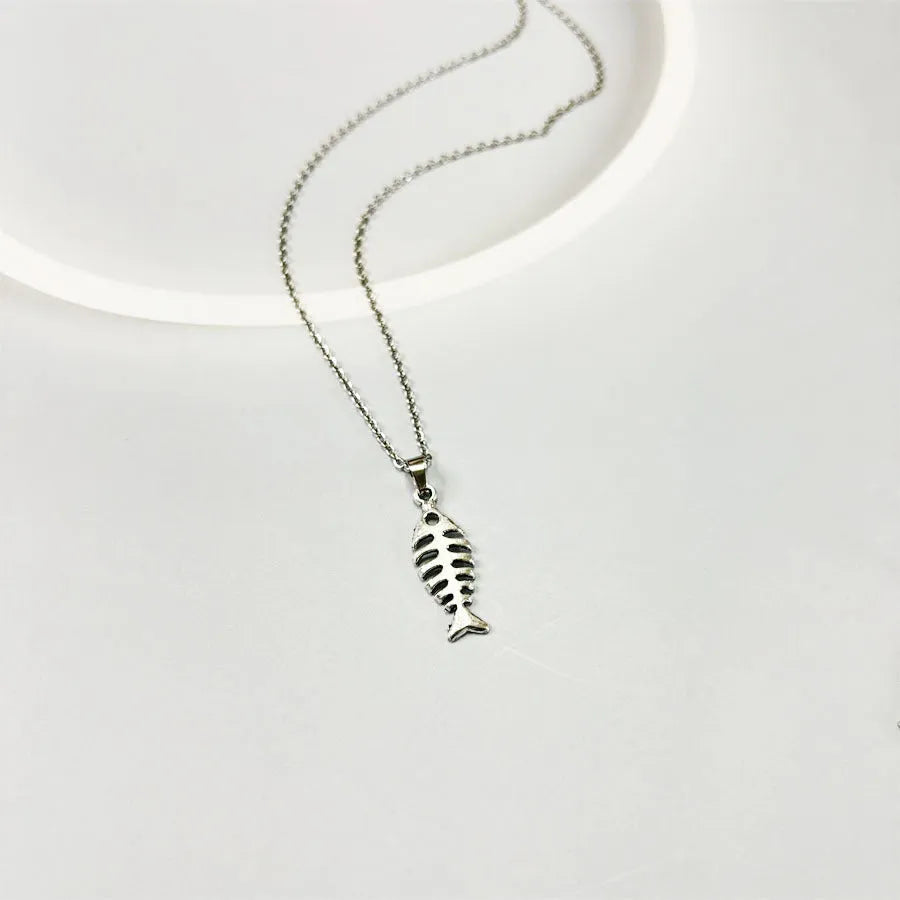Close-up of silver fishbone pendant earrings on a white background, showing O-shaped chain detail.
