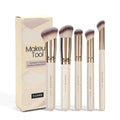 Five apricot-coloured makeup brushes including angled blusher brush for cheek application