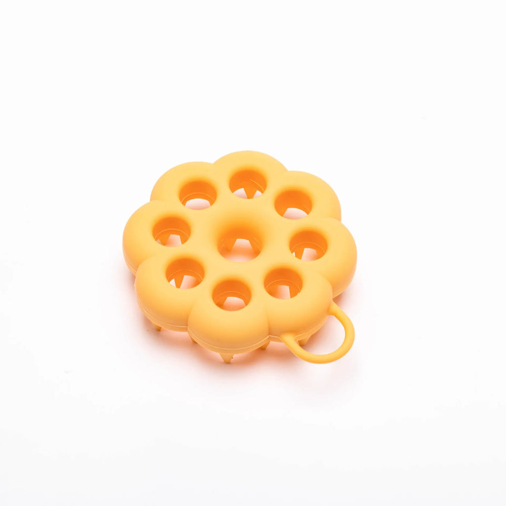 Blue silicone pet grooming brush with soft pins and ergonomic handle for wet or dry use.