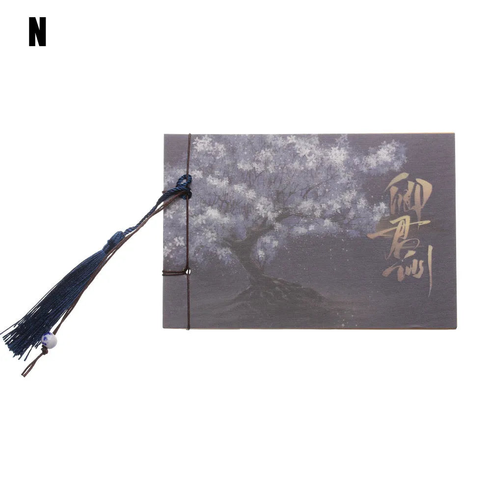 Kraft paper notebook with tassel bookmark showing hand-stitched binding and blank interior pages
