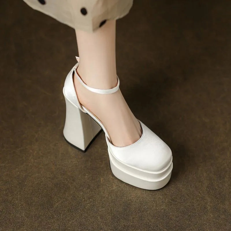 Women's white chunky heel platform pumps with a round toe and waterproof upper on a rubber sole.