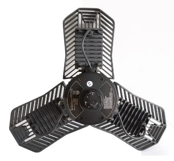 A foldable silver aluminium industrial LED garage lamp showing its waterproof housing and wide-angle light beam.