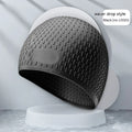 Adult silicone swimming cap with water drop texture in various colour options on a white background.