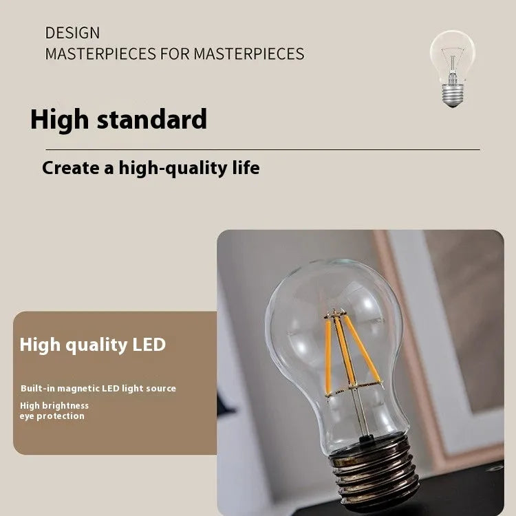 Small black suspension bulb night lamp with iron art body on a wood grain base for desktop decoration.