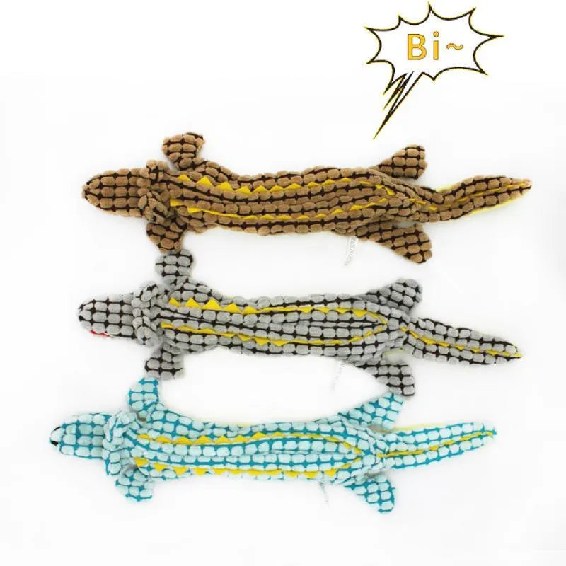 Crocodile-shaped plush dog toy with corduroy fabric detailing and squeaker inside