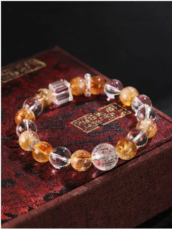 Handmade women's bracelet with white crystal beads, freshwater pearls, and yellow crystal accents
