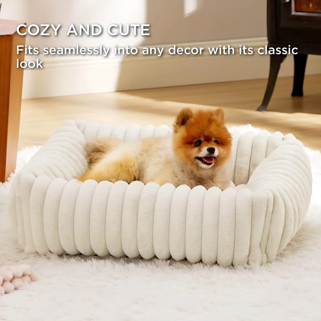 A beige winter-warm cushioned pet bed for cats and dogs on a wooden floor.