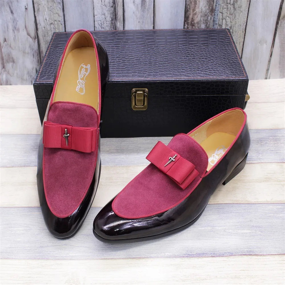 Men's black patent leather low-top dress shoes with a tassel detail on a rubber sole.