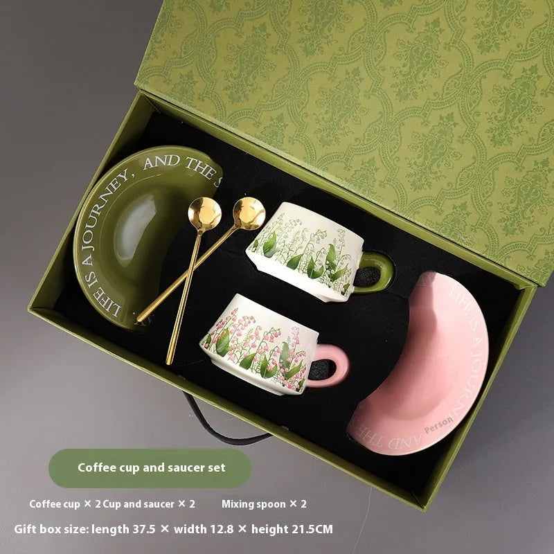Ceramic coffee cup and saucer set for two with stirring spoons in two design choices.