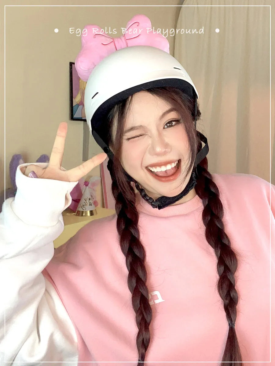 A soft plush bow decoration for helmets in red, peach pink, and rose pink colours.