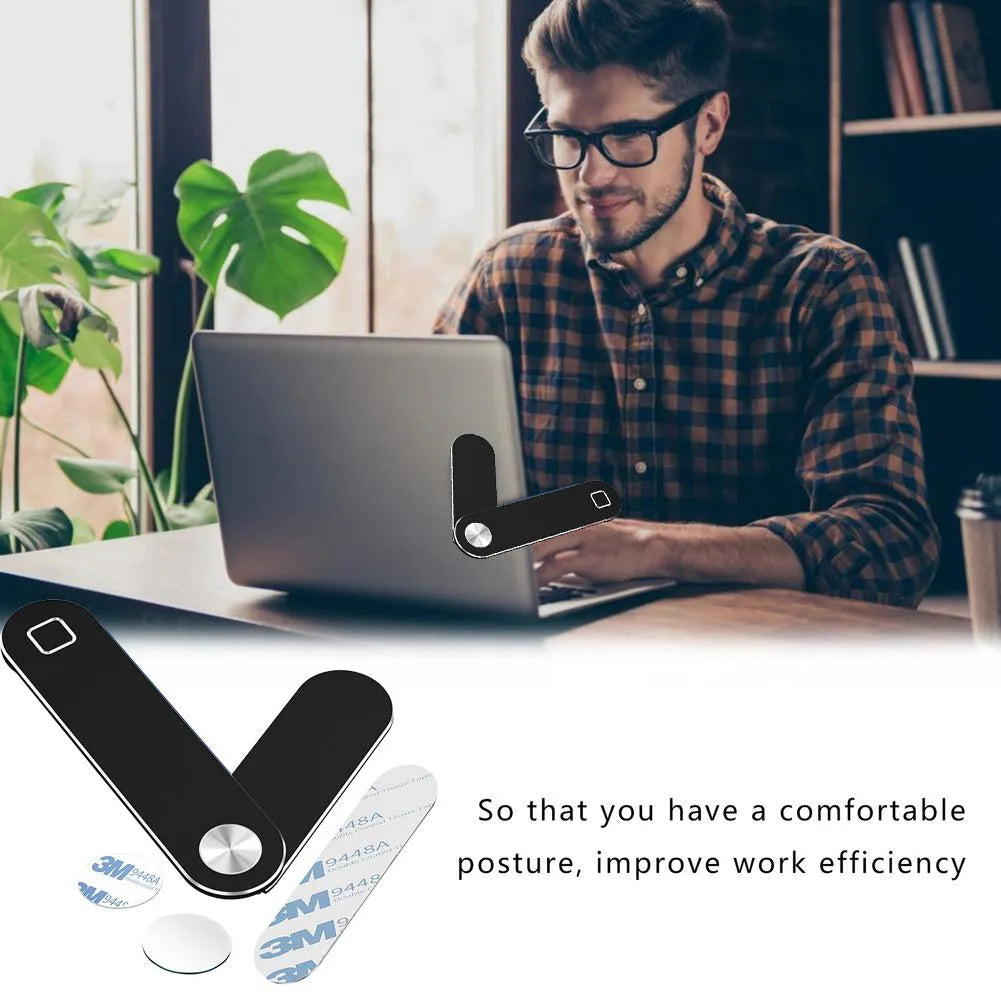 Black aluminium magnetic phone holder clipped to the side of a laptop screen with a smartphone attached.